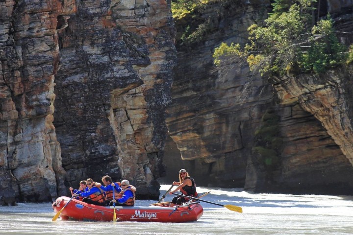 a man in a red raft in the water
