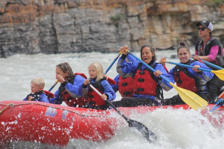 Juana Beede et al. riding on a raft