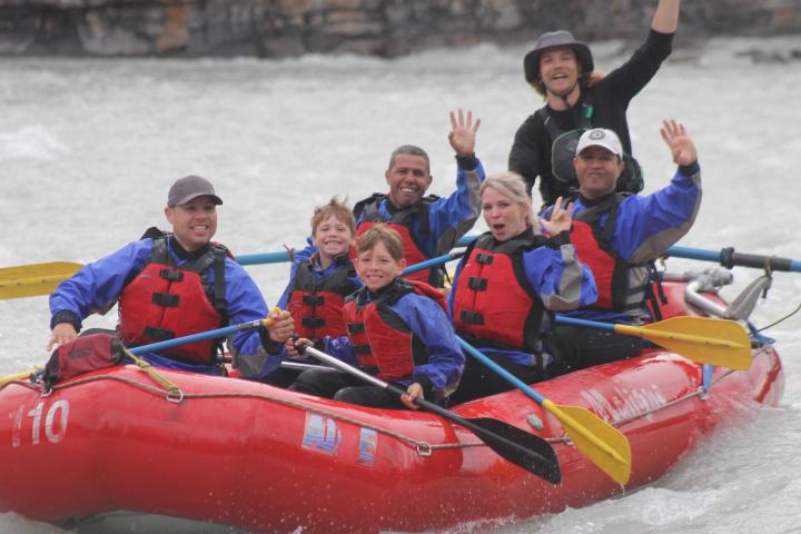 a group of people riding on the back of a boat