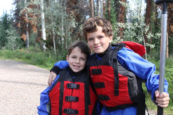 a little boy that is standing in the grass