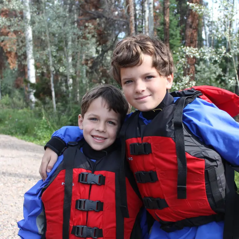 a little boy that is standing in the grass