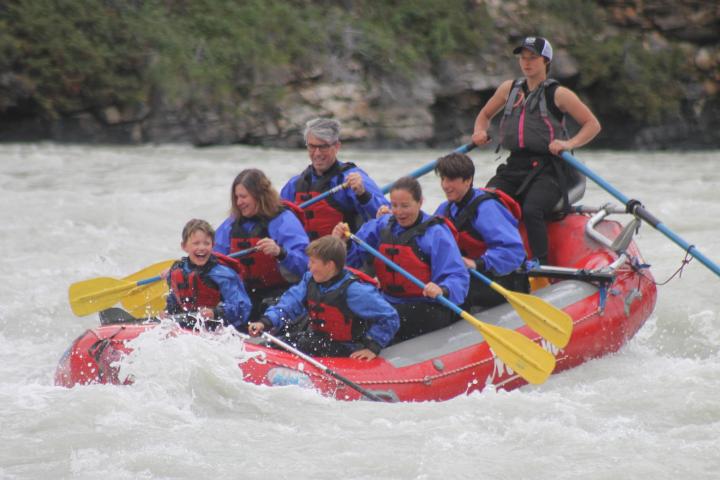 a group of people riding skis on a raft