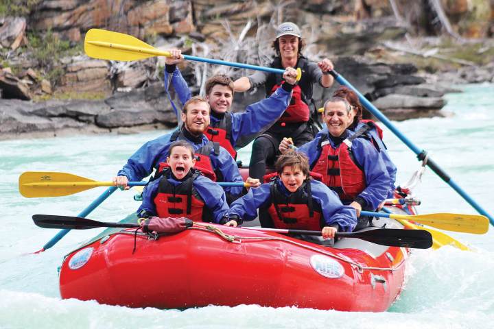 a group of people on a raft in a body of water