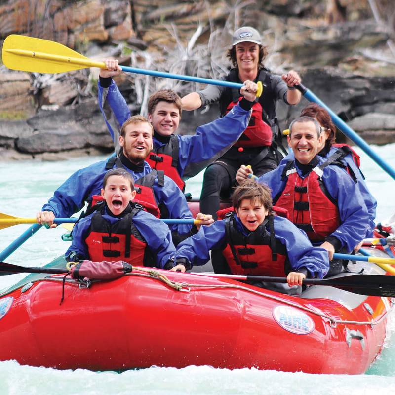 a group of people on a raft in a body of water