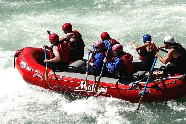 a man in a red raft in a body of water