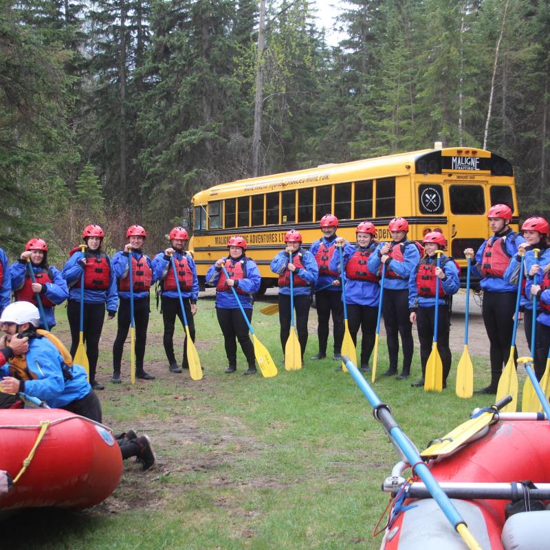a group of people riding on the back of a boat