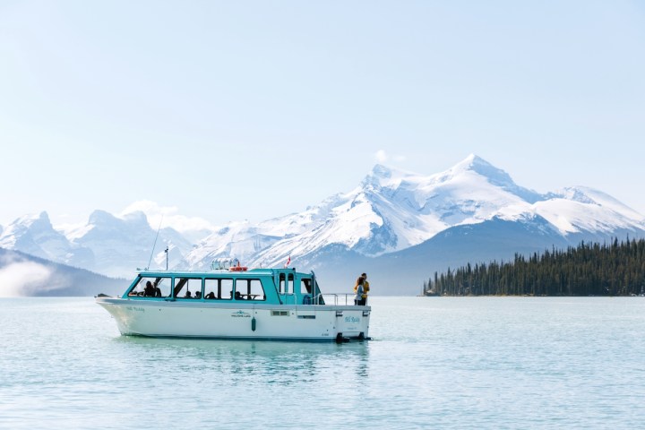 a boat on a body of water with a mountain in the background
