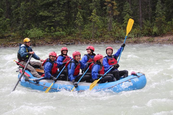 a group of people on a raft in a body of water
