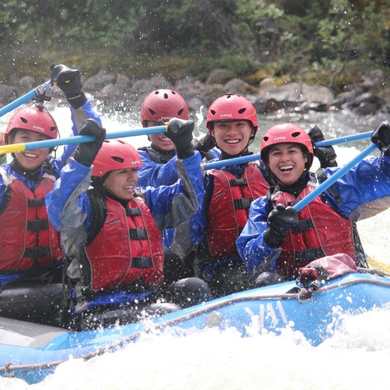 a group of people riding skis on a raft