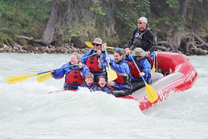 a group of people riding skis on a raft