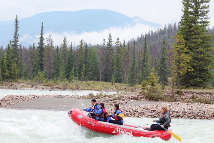 a group of people riding on the back of a boat