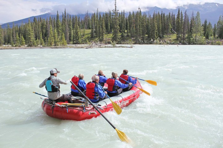 a group of people riding on the back of a boat