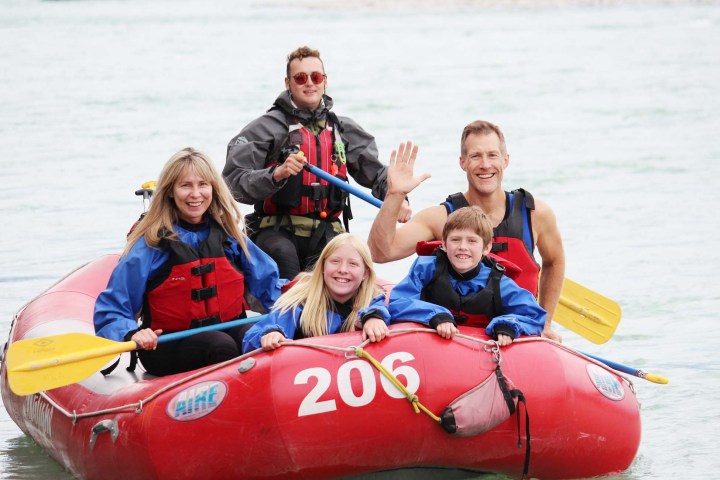 a group of people in a boat on a body of water