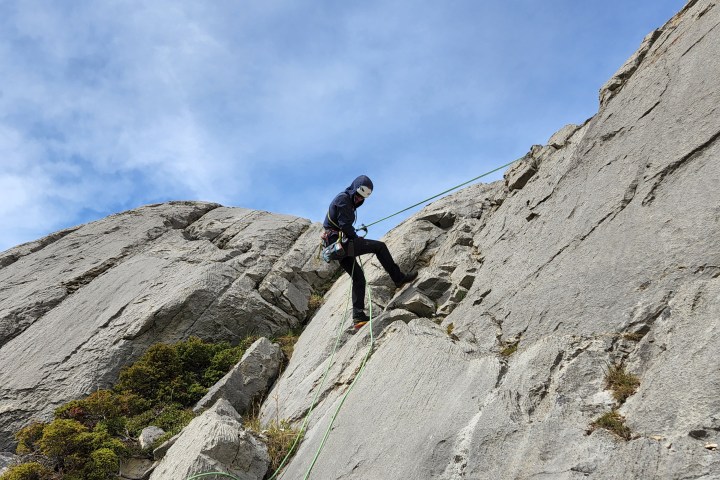 a person standing on a rocky hill