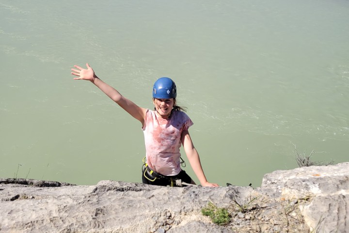 a man standing next to a body of water