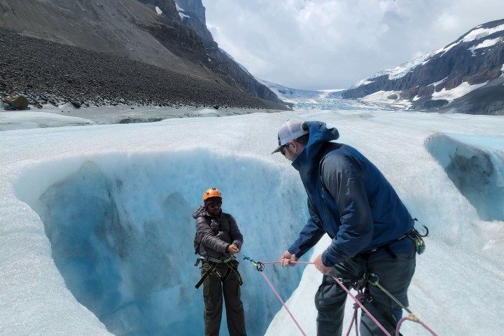 a man standing on top of a snow covered mountain