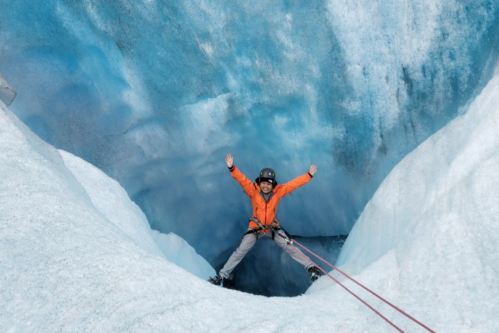 a man riding skis down a snow covered mountain