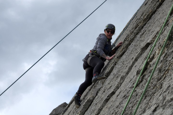 a person sitting on the side of a hill